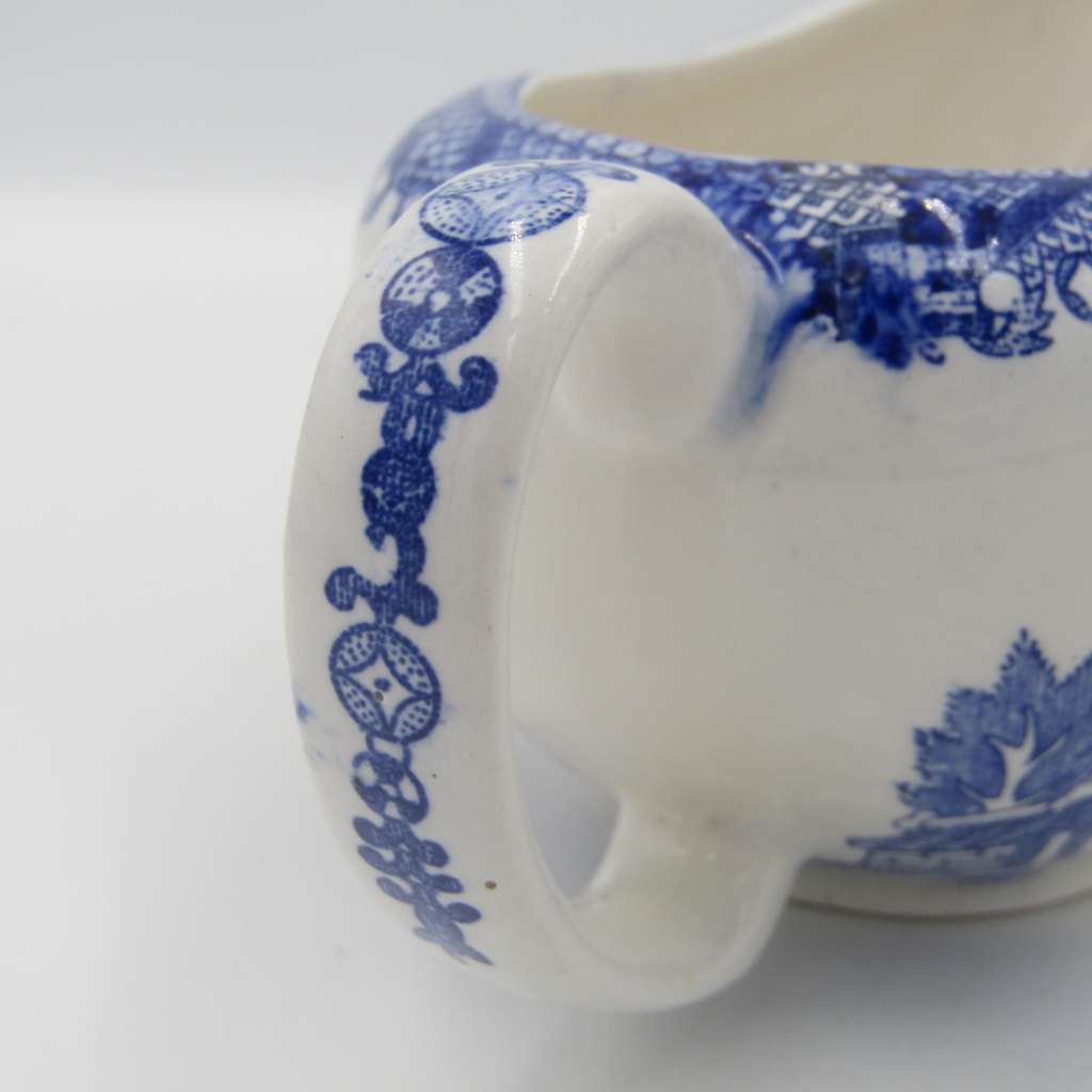Antique Willow Pattern sauce boat and saucer