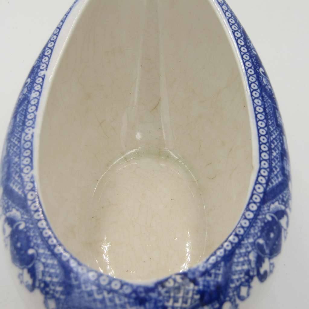 Antique Willow Pattern sauce boat and saucer