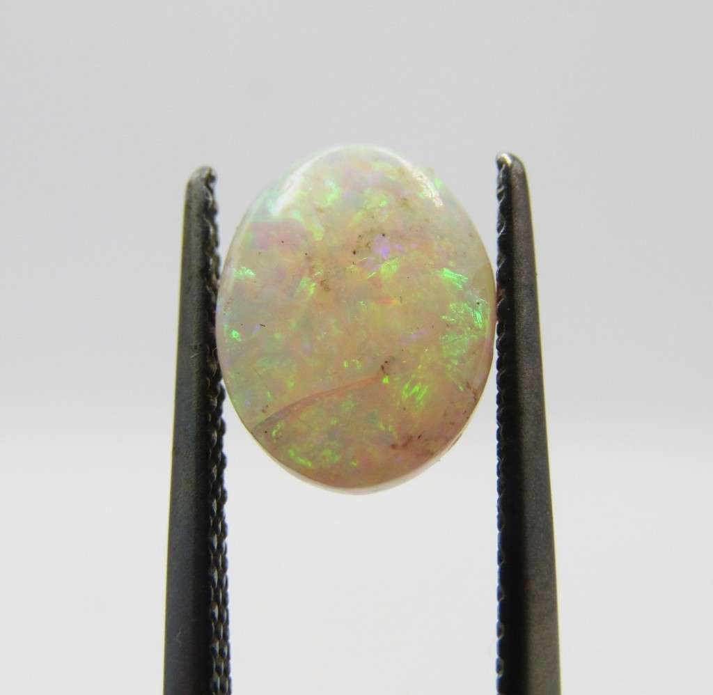 Beautiful orange & green flashes Opal of 1,21 carat - Oval Cabochon white opal