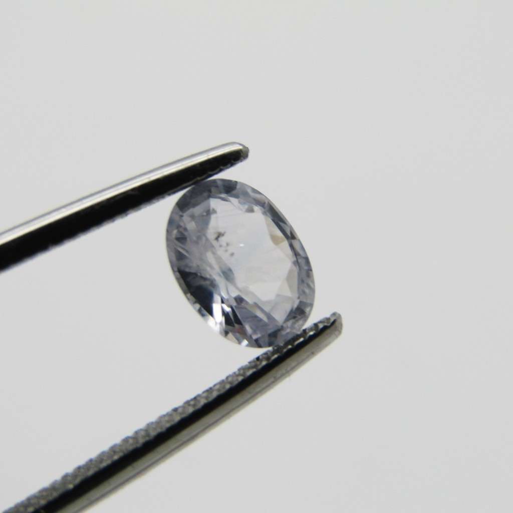 Natural Sapphire of 0,94 carat medium dark toned white - oval mixed cut with Gemlab certificate