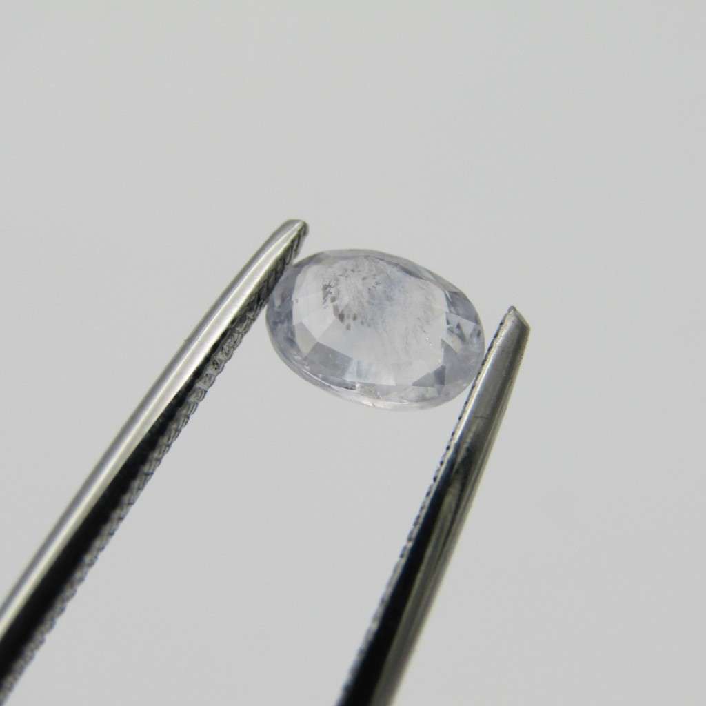 Natural Sapphire of 0,94 carat medium dark toned white - oval mixed cut with Gemlab certificate
