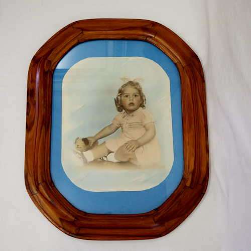 Photo of child in wooden frame