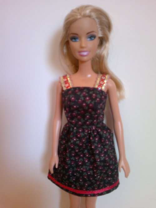 Barbie dress with sequin trim straps. Black and red print.
