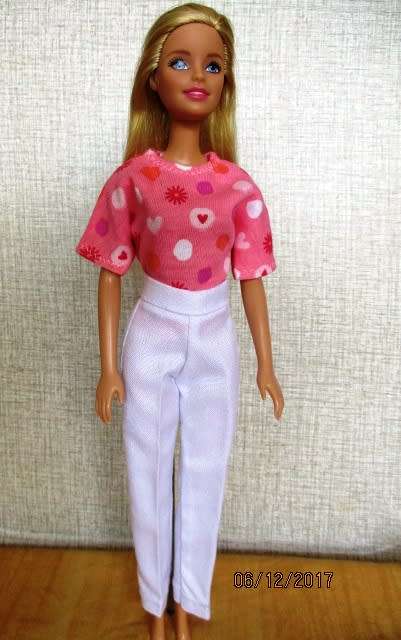 Barbie fitted white pants and pink print T-shirt.