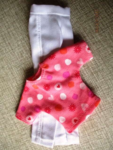 Barbie fitted white pants and pink print T-shirt.