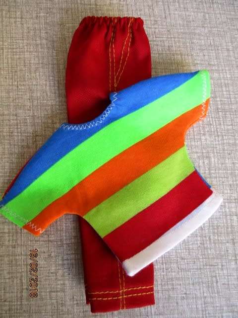 Ken - Barbie - red pants and bright striped T-shirt.