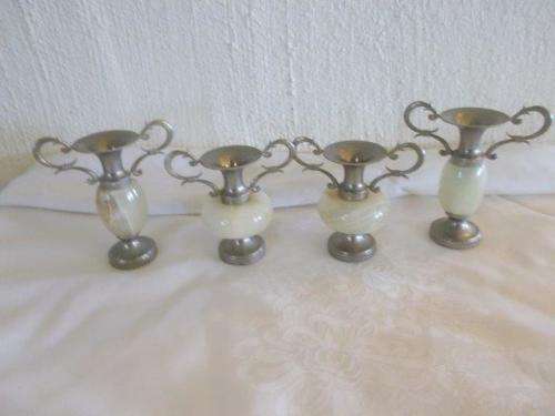 A collection of small metal vases with marble centers
