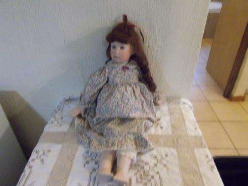 large porcelain doll wearing a flower dress