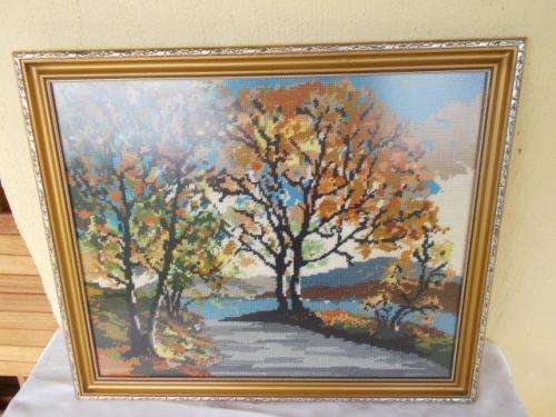 Framed Autumn style trees tapestry behind glass
