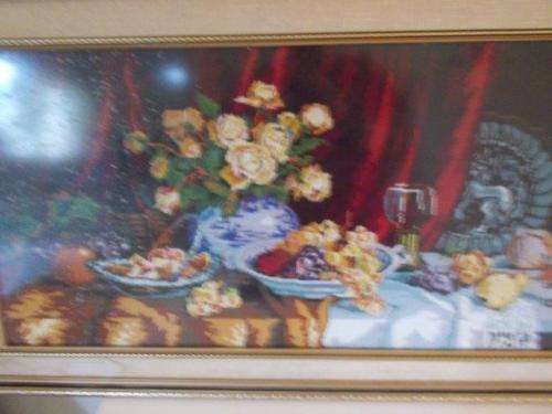 large framed fruit scene tapestry behind glass
