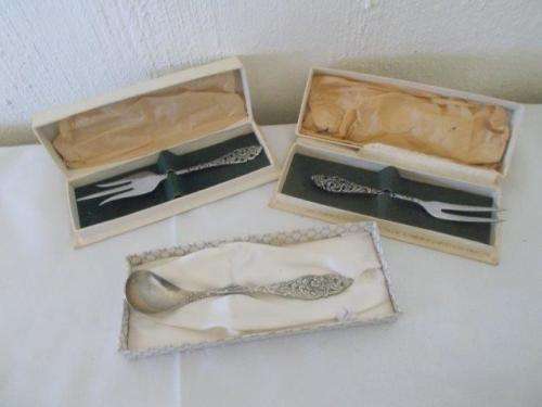 Three nicely boxed silver plated dutch style pickle forks and one spoon