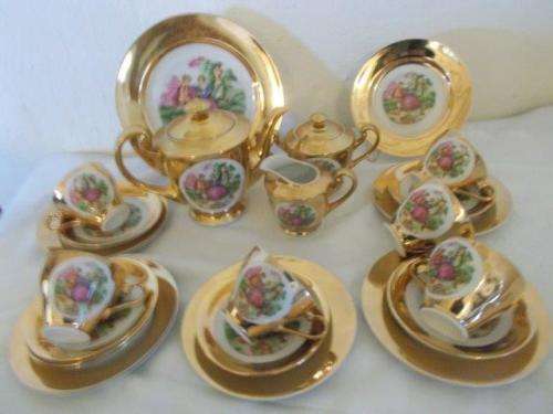 stunning complete gold in color porcelain romantic scene tea set