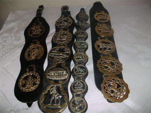 Four asstorted horse brass on a leather strap for the collector