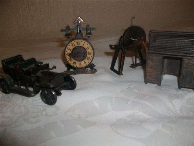 three assorted miniature metal sharpers and one other