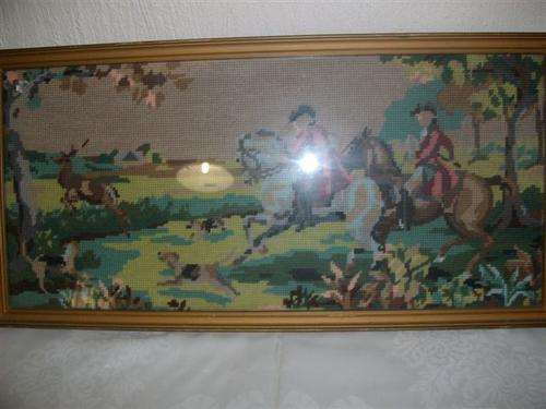 Framed hunting scence tapertry behind glass
