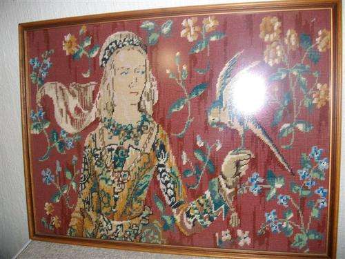 Framed large tapestry of a victange lady scene holding a bird behind glass