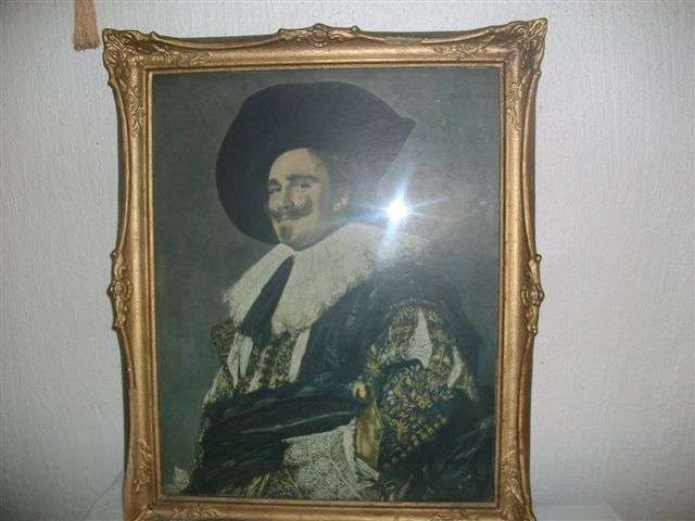 Vintage ornate frame with a vintage print of a man behind glass