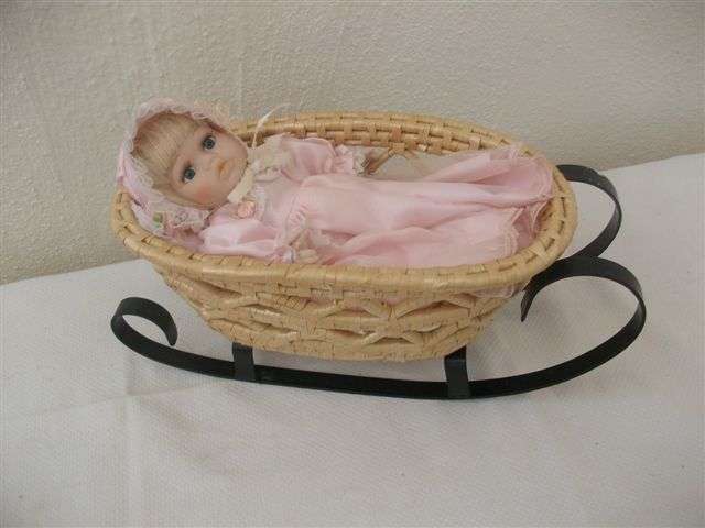 Sweet small porcelain doll in coat