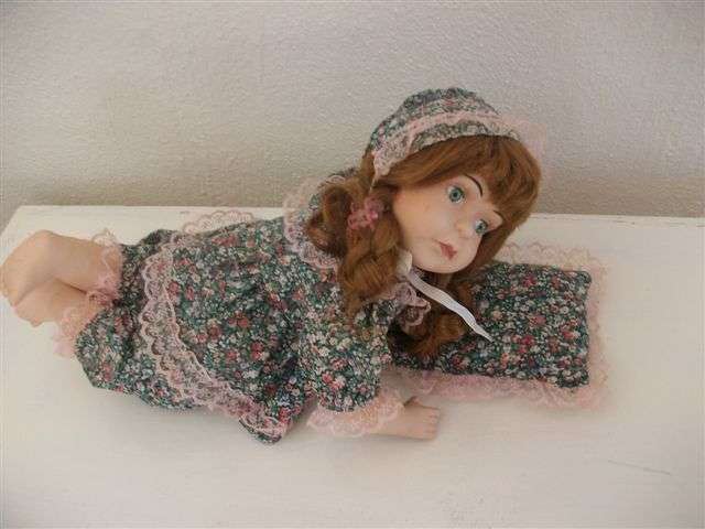 Nice porcelain doll with pillow