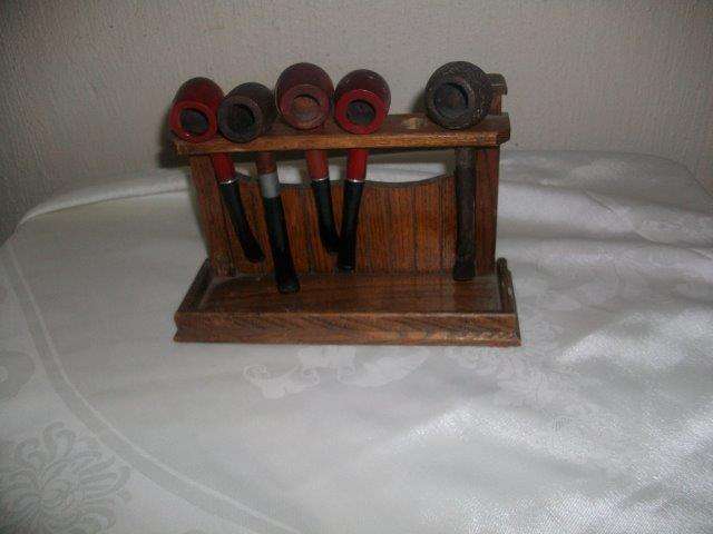 wooden pipe stand with a collection of pipes