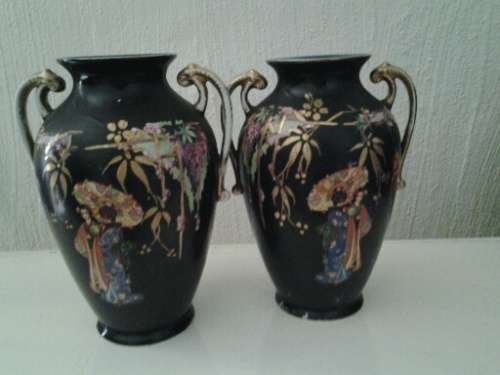 A pair of vintage black oriental scenes vases