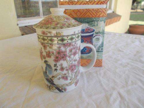boxed oriental tea cup with a tea infuser