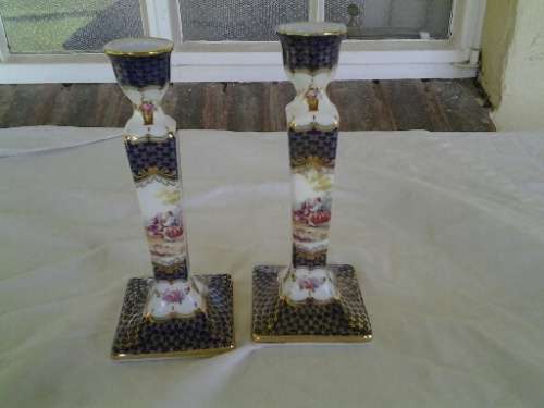 A pair of pretty decorative porcelain candle stick holders
