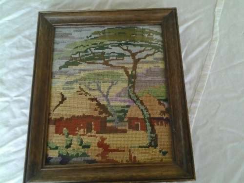 small framed nice zulu hut scene taperstry behind glass