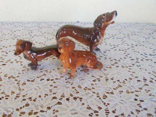 A set of three cute porcelain dachshund ,dogs figurines