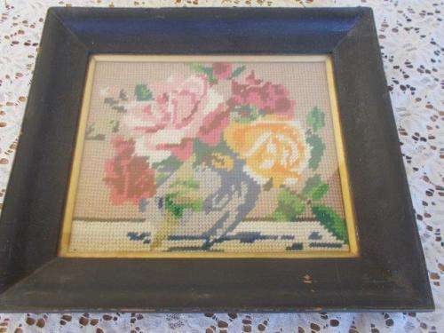 small vintage black wooden framed roses tapersty behind glass