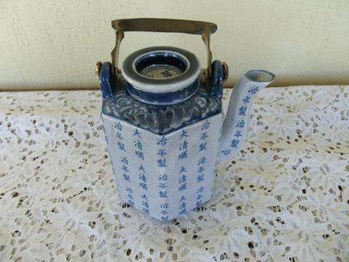 stunning oriental blue porcelain tea pot with a brass handle