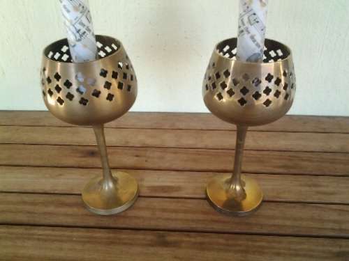 a pair of stunning brass goblets candle holders with candles