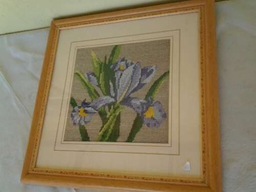 small framed lilac floral tapestry behind glass