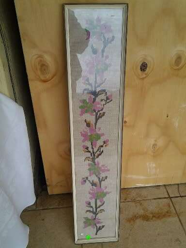 large framed pink floral scene behind glass