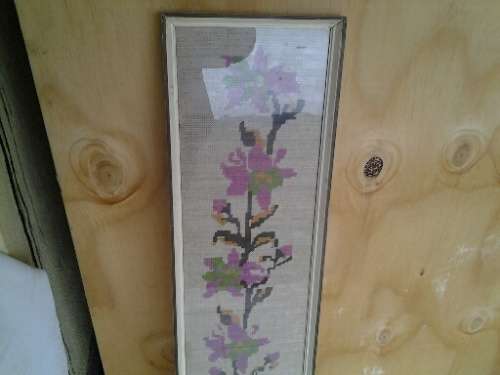 large framed pink floral scene behind glass