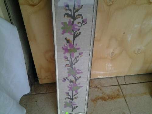 large framed pink floral scene behind glass