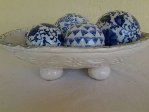 decorative white bowl filled with porcelain blue balls