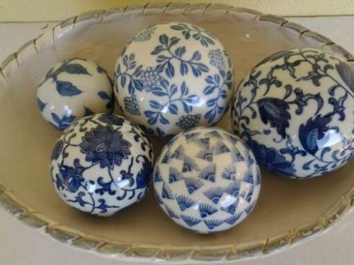 decorative white bowl filled with porcelain blue balls