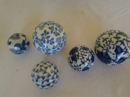 decorative white bowl filled with porcelain blue balls