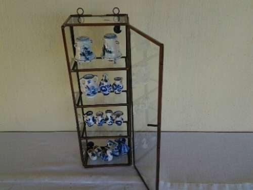 stunning little glass display case with some blue and white miniatures