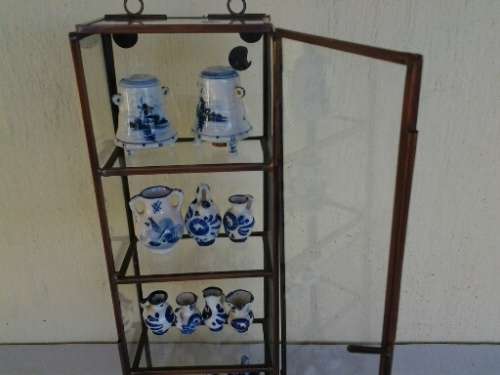 stunning little glass display case with some blue and white miniatures