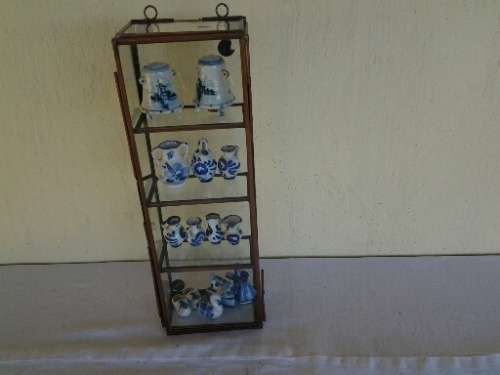 stunning little glass display case with some blue and white miniatures