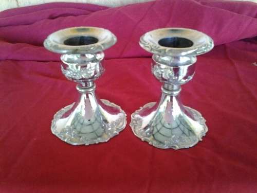 A pair of small pretty sliver plated chrome candle stick holders