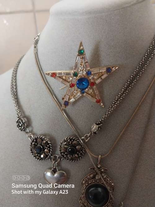 Three assorted necklaces and a star brooch