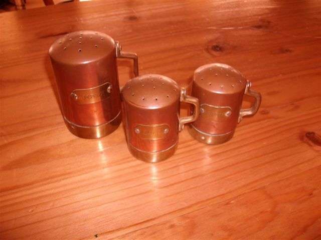 collection of three copper salt and pepper pots