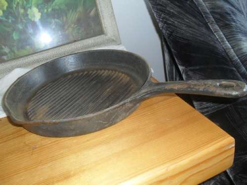 A CAST IRON PAN - 46cm long including handle  pan 29cm x 28cm  4cm deep