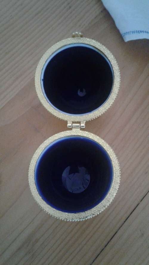 (NORR)A VINTAGE COBALT BLUE AND GOLD  PORCELAINE REPLICA HINGED FABERGE EGG with gold tone clasp.