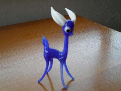 A minature vintage blue glass deer.