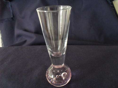 A PINK GLASS VASE WITH A SOLID BASE THAT HAS BUBBLES IN IT!