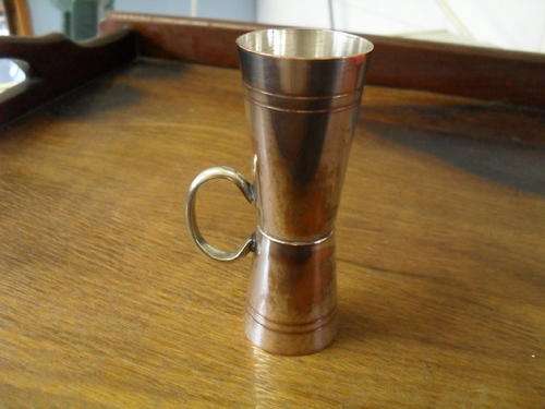 A SILVER PLATED TWO SIZED TOT MEASURER